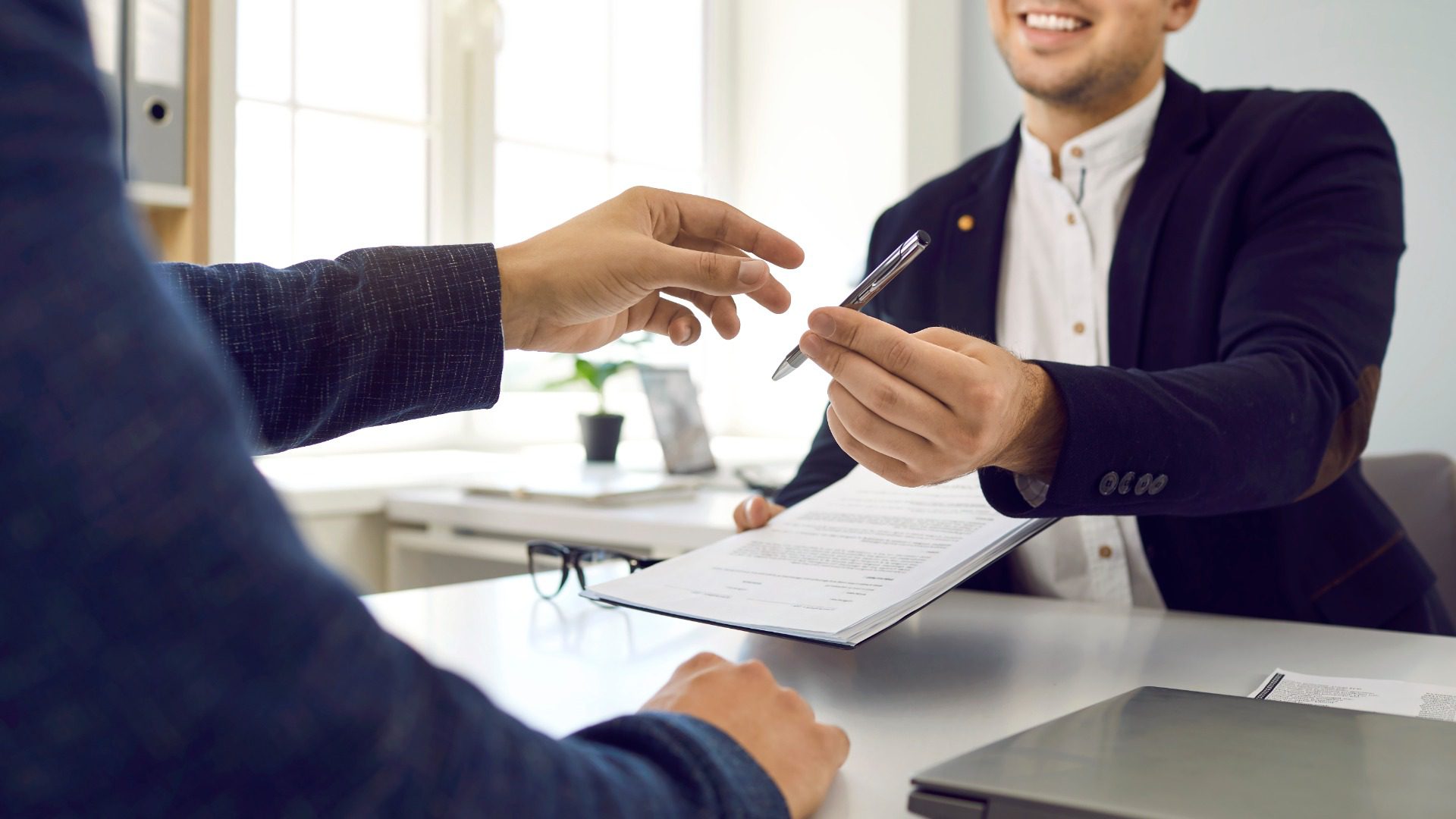 Two young people meet in the office, make a deal and sign a contract. Two young people meet in the office, make a deal and sign a contract.